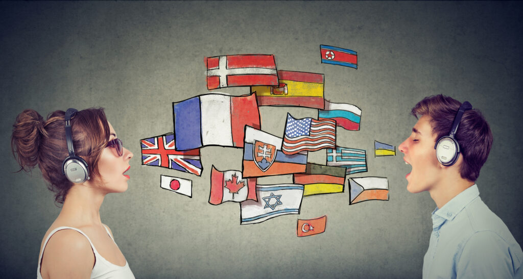 Two people speaking wearing headsets with various country flags between them