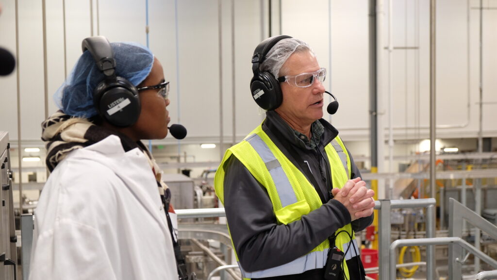 Tour guide and guests on a factory tour using two-way communication headset.