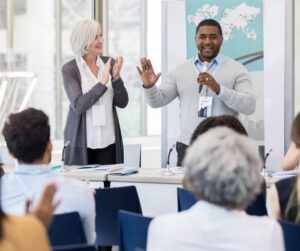 Man with microphone speaking go event guests