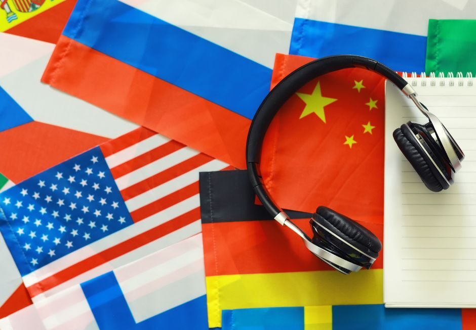 Overlapping country flags with headphones sitting on top