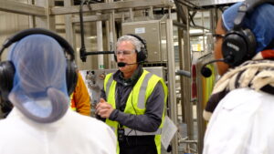 Tour guide uses audio headset to talk with visitors.