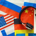 Overlapping country flags with headphones sitting on top